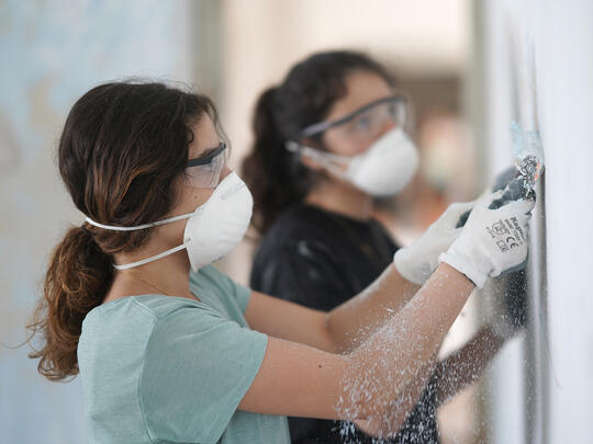 Armenie Terre De Vie Participant girls working in the school renovation