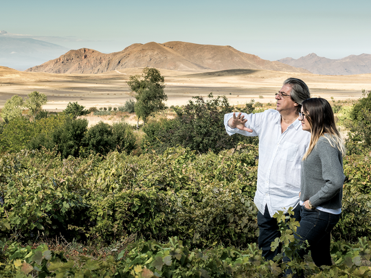Vahe and Aimee Keushguerian overlooking a vineyard in Khachik Village, Vayots Dzor.