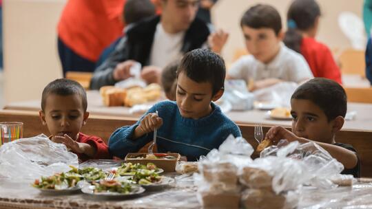 Armenian youth from Artsakh enjoying a full course warm meal in the Vayots Dzor region of Armenia.